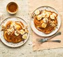 Rustic plate shows pancakes topped with banana and caramel
