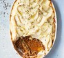 Braised pork cottage pie with celeriac topping served in a casserole dish