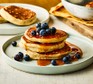 Three stacked buckwheat American pancakes with blueberries