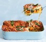 Caramelised squash and spinach lasagne in a baking dish