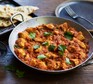 Chicken Madras curry in a balti dish with naan bread