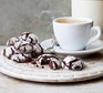 Chocolate fudge crinkle biscuits served with a coffee