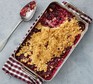 Damson crumble served in a dish
