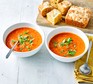 A bowl of tomato soup with cheesy cornbread
