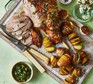 Carved roast lamb with hasselback potatoes on the side served on a wooden platter