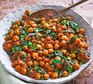 Chickpea curry in a round dish with spoon
