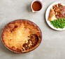 Cottage pie in dish with plate and gravy boat