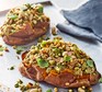 Two baked sweet potatoes topped with pesto, cannellini bean and tuna
