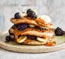 Protein pancakes served with maple syrup and fruit