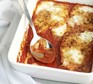 Chicken parmesan in a large oven dish with serving spoon