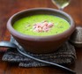 Pea & ham soup in a rustic bowl with spoon & napkin