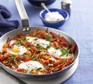 Menemen made with eggs and peppers in a silver frying pan