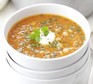 Red lentil, chickpea & chilli soup in a bowl with Greek yogurt and coriander garnish