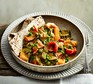 A serving of slow cooker vegetable curry with flatbread