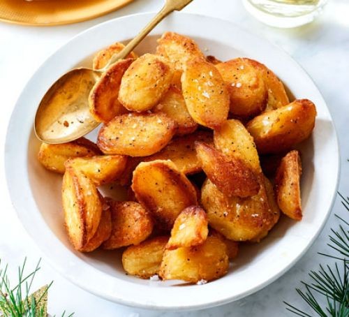 Roast potatoes in a bowl with spoon
