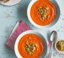 Smoky tomato soup with preserved lemon & green olive salsa served in bowls