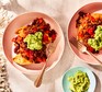 Turkey chilli divided between two bowls with guacamole alongside